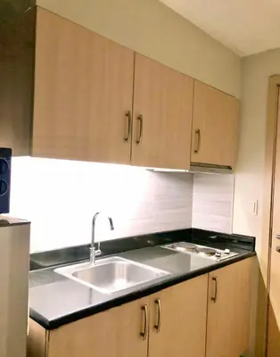 a kitchen with a sink and a counter top at Cosy Light Residences Unit Staycation in Manila