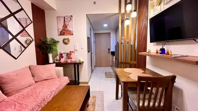 a living room with a couch and a table at M&B Staycation in Manila