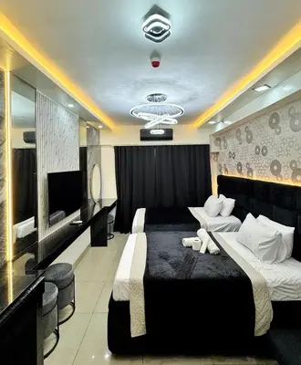 a hotel room with two beds and a television at M&M Condostay at Shore 2 Residences Tower 3 in Manila