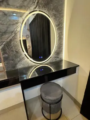 a bathroom with a vanity with a mirror and a stool at M&M Condostay at Shore 2 Residences Tower 3 in Manila