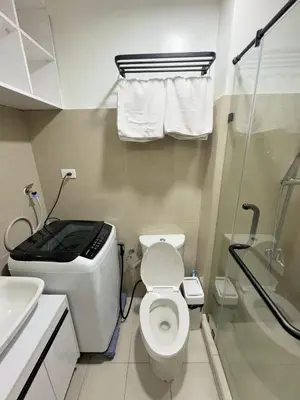a small bathroom with a toilet and a sink at M&M Condostay at Shore 2 Residences Tower 3 in Manila