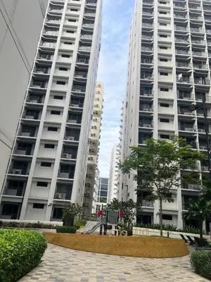 two tall white buildings with trees in front of them at Seaside Serenity in Manila