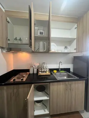 a kitchen with a sink and a counter top at Seaside Serenity in Manila