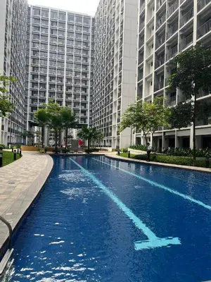 a swimming pool in a city with tall buildings at Seaside Serenity in Manila