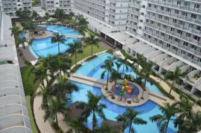 an aerial view of the pool at the resort at Artsy 110sqm 2br in MOA 200mbps Wifi XBOX Printer in Manila
