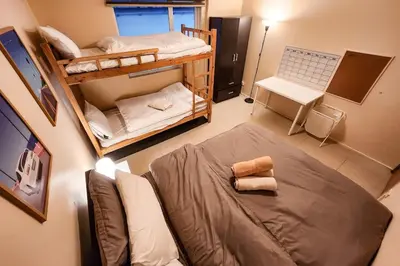 a room with two bunk beds and a couch at Amazing View 2br MOA, 98 sqm XBOX 200mbps, Printer in Manila