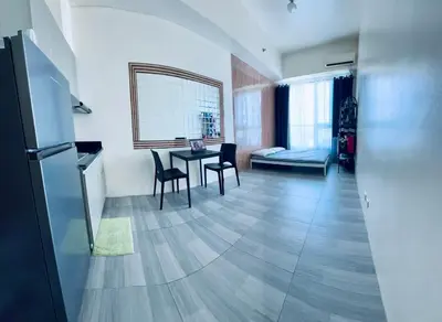 a kitchen and living room with a table and chairs at The Beacon Tower in Manila