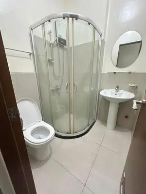 a bathroom with a shower and a toilet and a sink at The Beacon Tower in Manila