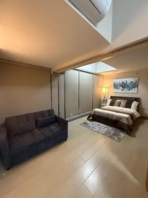 a large bedroom with a bed and a couch at Superior Studio Eastwood Global Plaza Luxury Residence in Manila