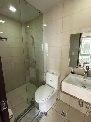 a bathroom with a toilet and a shower and a sink at Superior Studio Eastwood Global Plaza Luxury Residence in Manila