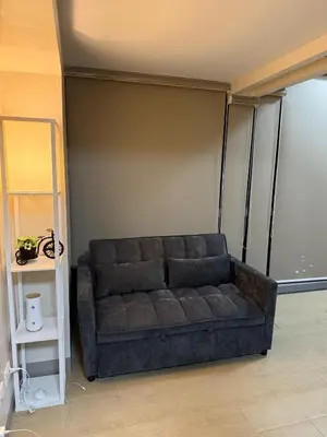a living room with a couch in a room at Superior Studio Eastwood Global Plaza Luxury Residence in Manila