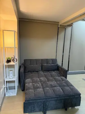 a living room with a couch in a room at Superior Studio Eastwood Global Plaza Luxury Residence in Manila