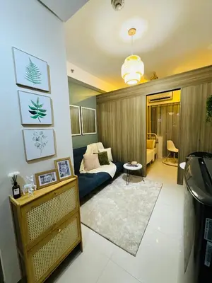 a living room with a couch and a table at Fame residences in Manila