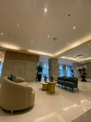 a lobby with couches and chairs in a building at Fame residences in Manila