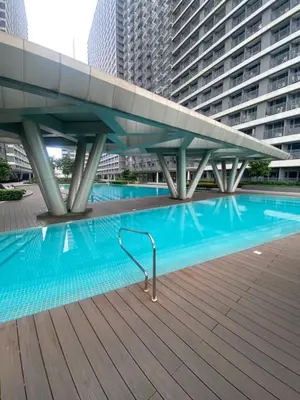 a swimming pool in the middle of a building at Fame residences in Manila