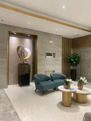 a lobby with two blue chairs and a trophy at Fame residences in Manila