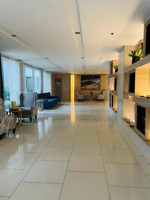 a large living room with a large white tile floor at Shell Residences with MOA View near NAIA - Aiza's Place in Manila