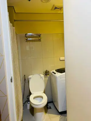 a small bathroom with a toilet and a sink at Shell Residences with MOA View near NAIA - Aiza's Place in Manila