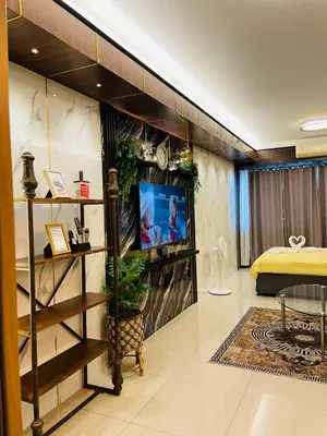 a living room with a tv and a bedroom at Shell Residences with MOA View near NAIA - Aiza's Place in Manila