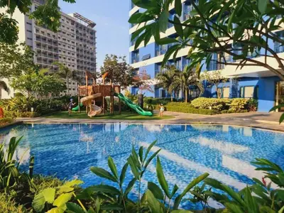 a swimming pool with a playground and a slide at 1LDK Air Studio in Makati City in Manila