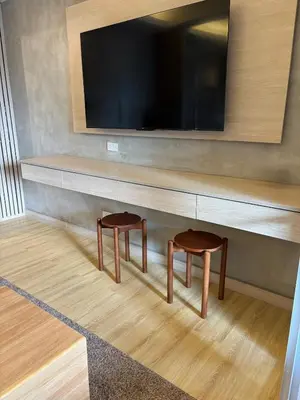 a living room with two stools under a tv at 1LDK Air Studio in Makati City in Manila
