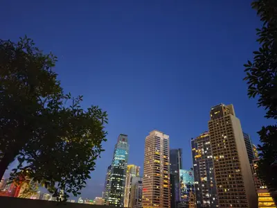 a city skyline at night with tall buildings at City Staycation Condo-SM Jazz in Manila