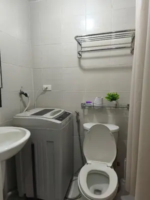 a small bathroom with a toilet and a sink at City Staycation Condo-SM Jazz in Manila