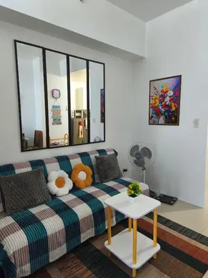 a living room with a couch with stuffed animals on it at City Staycation Condo-SM Jazz in Manila
