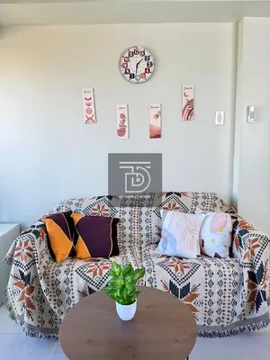 a living room with a couch and a table at Shore 3 Tower 1 Condo staycation near MOA - DT in Manila