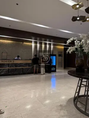 a lobby with people standing at a counter in a building at Shore 3 Tower 1 Condo staycation near MOA - DT in Manila