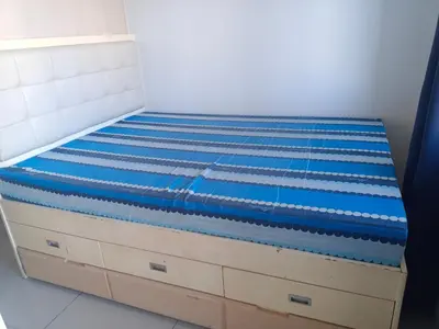 a bed with blue sheets on top of it at Sea Reaidence Tower E in Manila