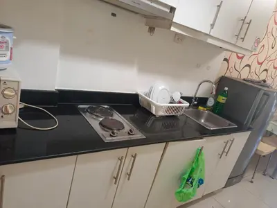 a small kitchen with a sink and a stove at Sea Residence Tower EF in Manila