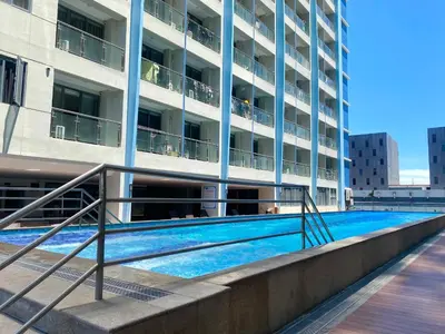a swimming pool in front of a building at City Center Executive Hotel-Near Manila Airport and PITX in Manila
