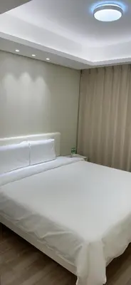 a large white bed in a room with a ceiling at City Center Executive Hotel-Near Manila Airport and PITX in Manila