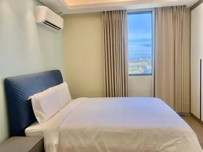 a hotel room with a large bed and a window at City Center Executive Hotel-Near Manila Airport and PITX in Manila