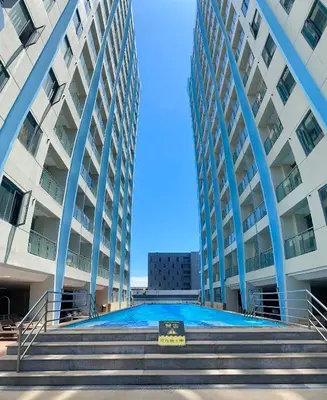 a view of a large building with blue columns at City Center Executive Hotel-Near Manila Airport and PITX in Manila