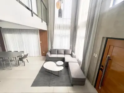 a living room with a couch and a table at CASA GUADA - Villa & Pool House Staycation in Postema