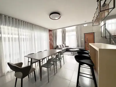 a dining room with a table and some chairs at CASA GUADA - Villa & Pool House Staycation in Postema