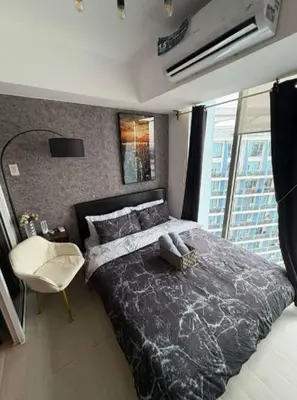 a bedroom with a large bed and a large window at Celestial Sphere Staycation at Azure Urban Resort Residences in Manila