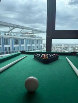 a pool table with a ball on top of it at Celestial Sphere Staycation at Azure Urban Resort Residences in Manila