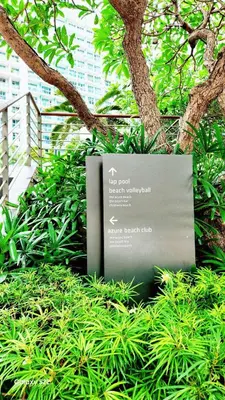 a sign in the middle of some green plants at Aerith's Haven Azurecation in Manila