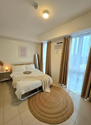a bedroom with a bed and a large rug at Casa de Porch in Manila