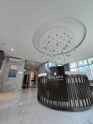 a lobby with a chandelier in the middle of a building at Casa de Porch in Manila