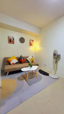 a living room with a couch and a table at Casa de Porch in Manila