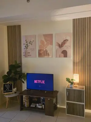a living room with a television on a table at Casa de Porch in Manila