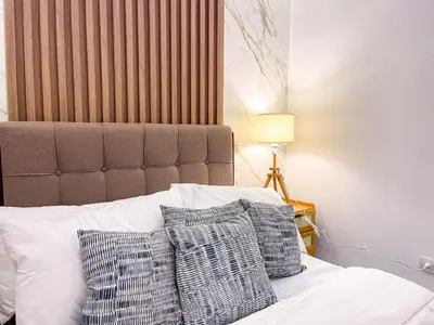 a bed with two pillows on top of it at Cozy & Chic 1BR near Mall of Asia - S Residences in Manila