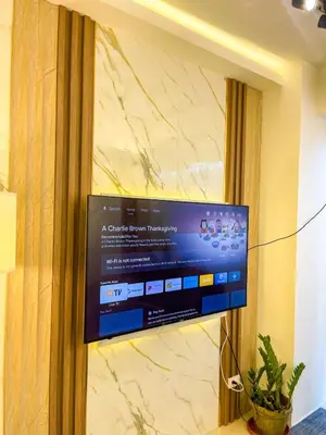 a flat screen tv hanging on a wall at Cozy & Chic 1BR near Mall of Asia - S Residences in Manila