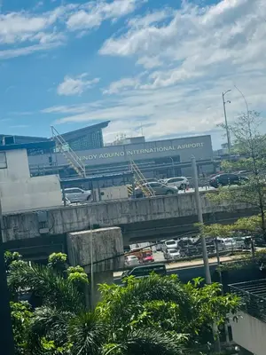 a view of a busy highway with a large airport at Pasay Airport Condotel by ASD in Manila