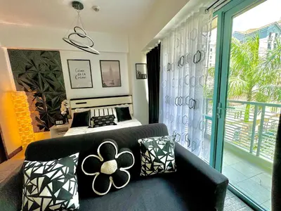 a living room with a couch and a bed at Pasay Airport Condotel by ASD in Manila