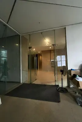 an empty office with a glass door and a desk at Lil Max Staycation in Manila